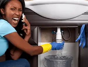 Emergency plumbing repair for a leaking sink drain under a bathroom vanity in San Mateo, CA