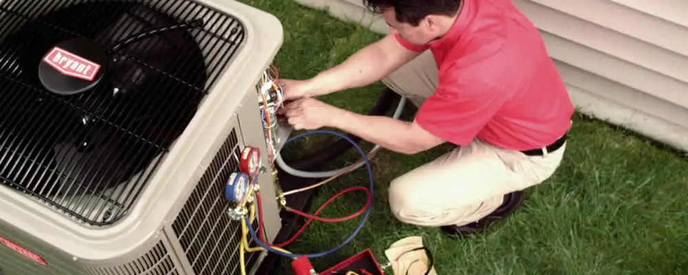 HVAC technician servicing an outdoor air conditioner unit in San Mateo, CA