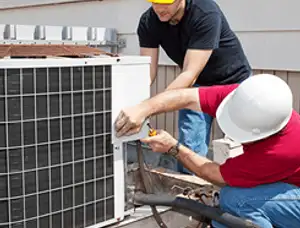 HVAC technicians repairing an outdoor AC unit on a rooftop in San Mateo, CA