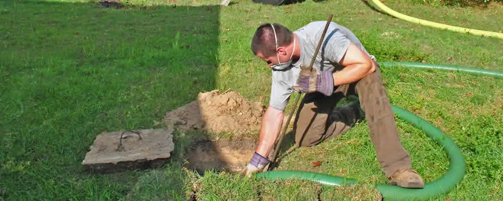Septic pumping technician servicing a residential septic tank in San Mateo, CA
